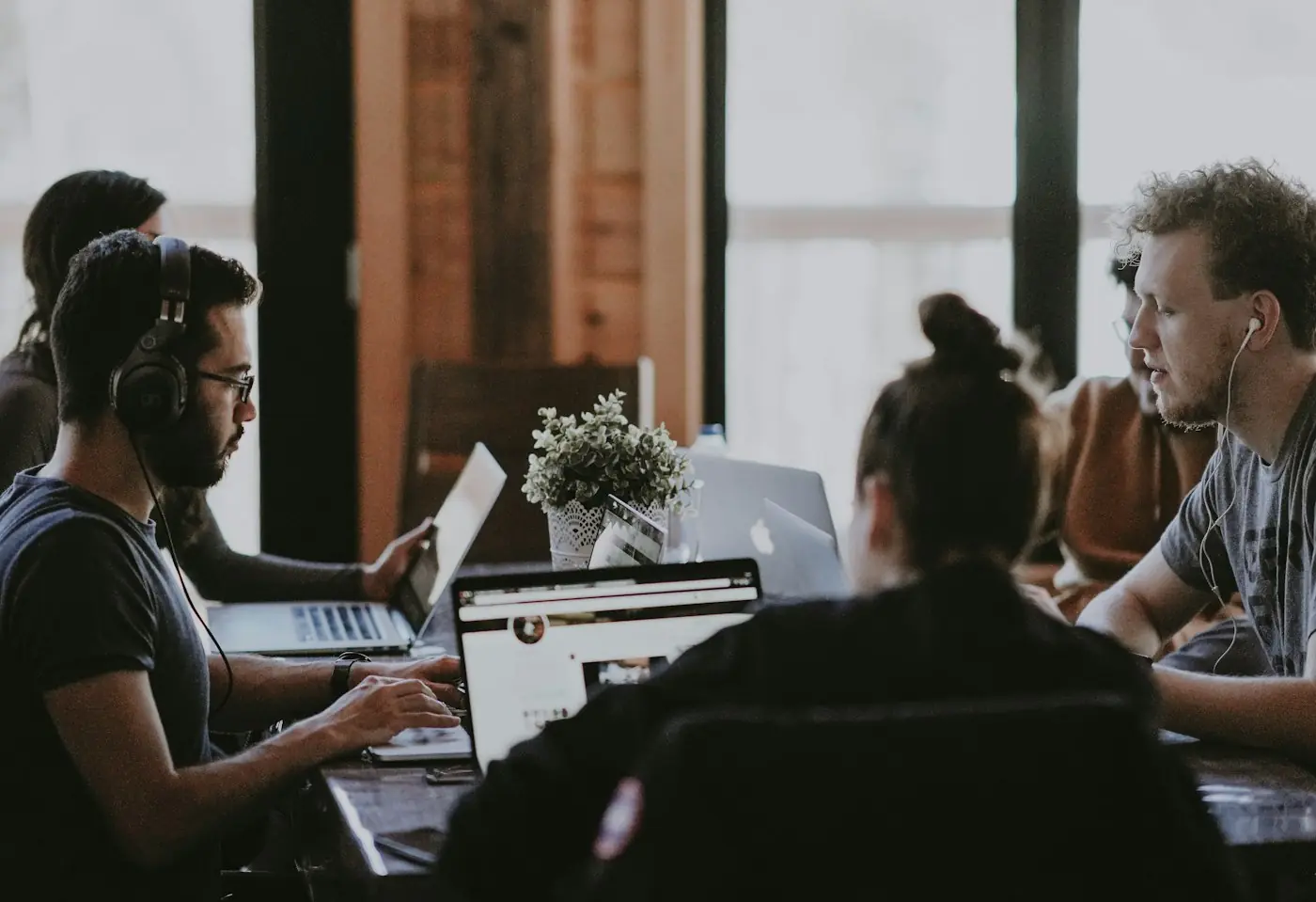 About Hero Team gathered around a table during a working session