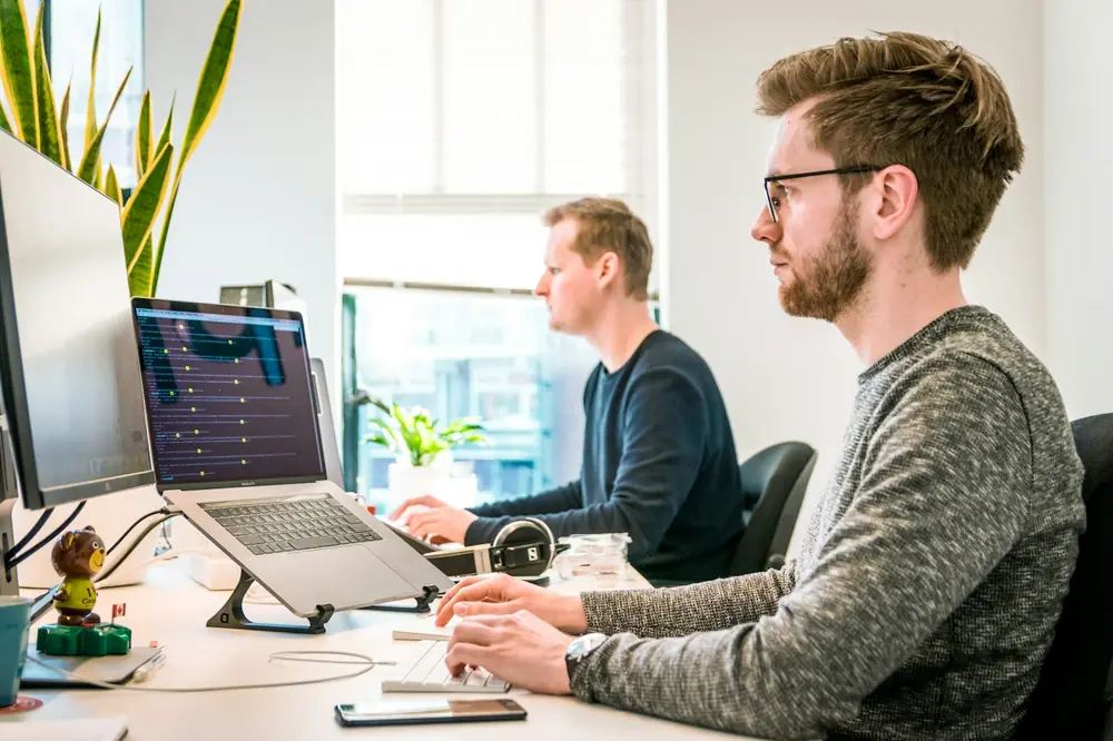 Team members working together at their computers