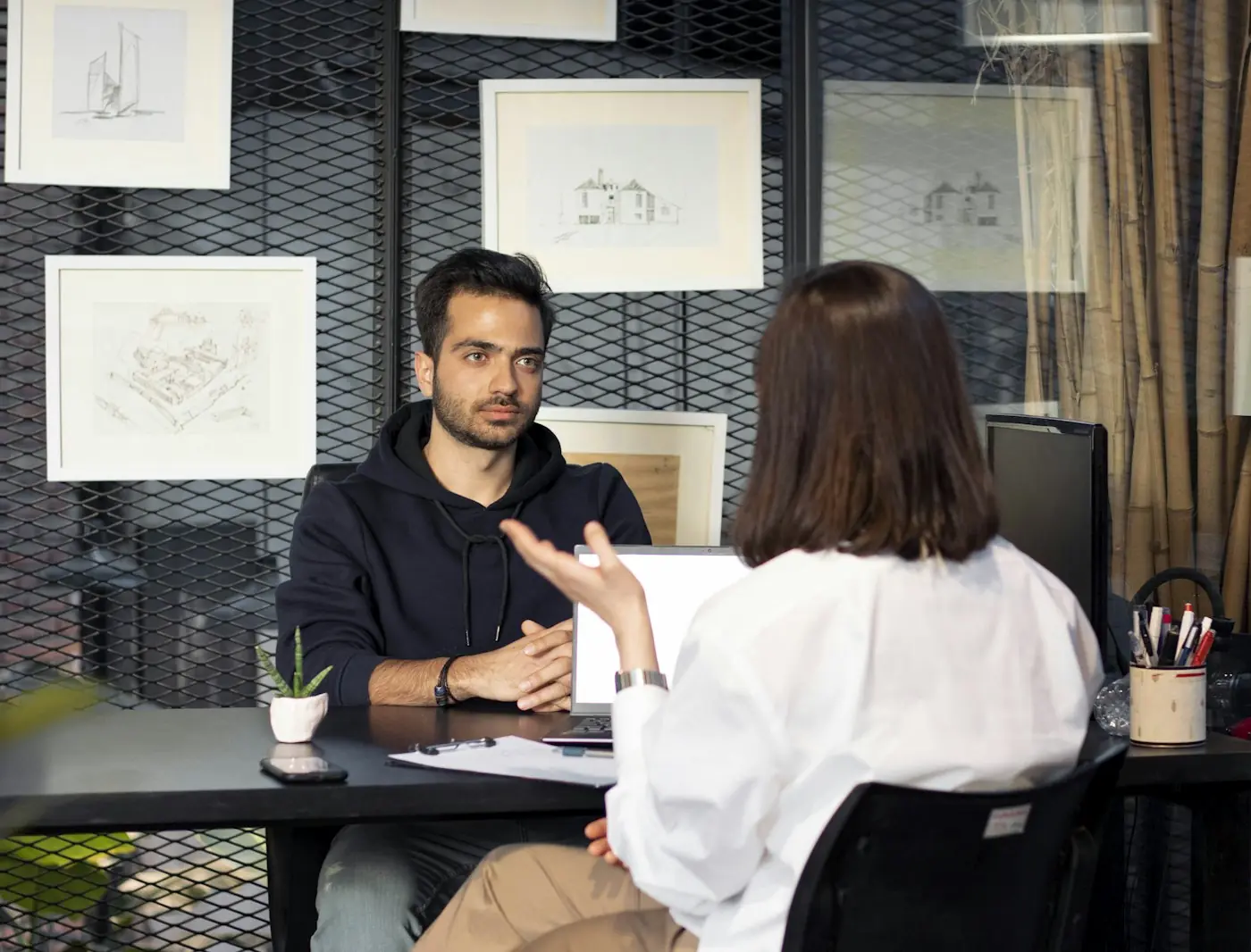 Hiring manager talking with a candidate across a desk