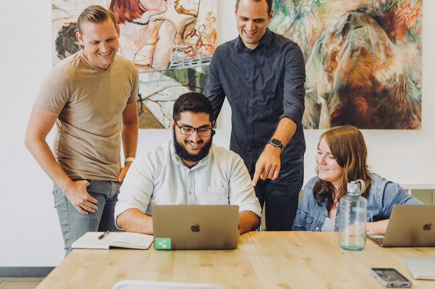 Hub Marketing Marketing team smiling around a laptop